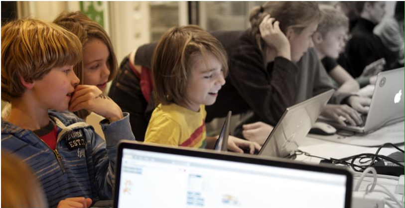 Kids sitting by computers